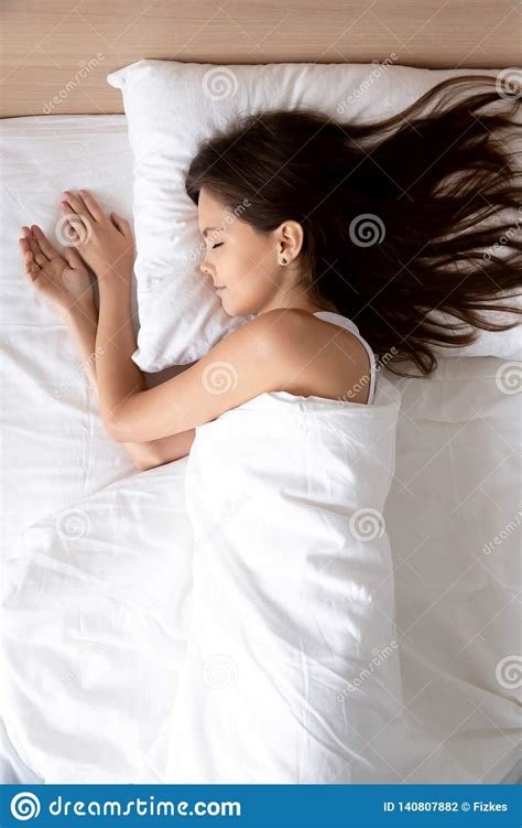 Vertical Beautiful Young Woman Sleeping In Comfortable Bed Stock Photo