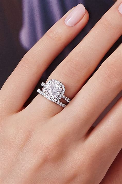 A Woman S Hand With Two Engagement Rings On It
