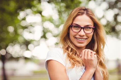 Premium Photo Portrait Of Smiling Woman Wearing Eyeglasses With Hands Clasped