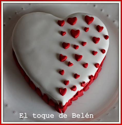 A Heart Shaped Cake With Red And White Icing On Its Side In The Shape Of A Heart
