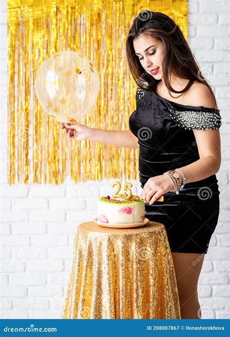 Beautiful Brunette Woman In Black Party Dress Celebrating Her Birthday Cutting The Cake Stock