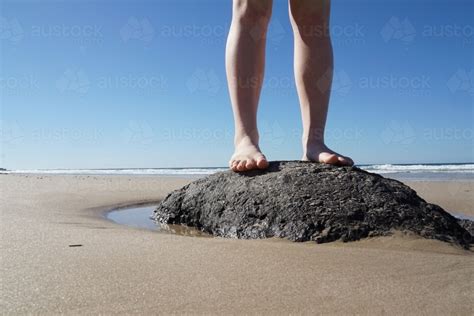 Image Of Feet Standing On Rock At Beach Austockphoto