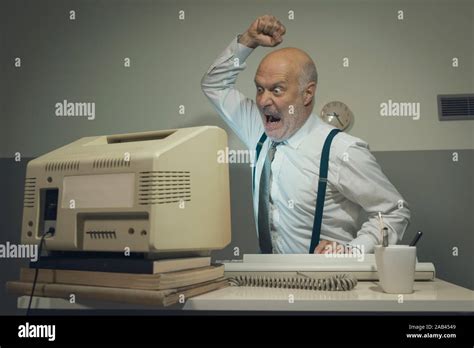 Angry Stressed Office Worker Hitting His Old Broken Computer Stock