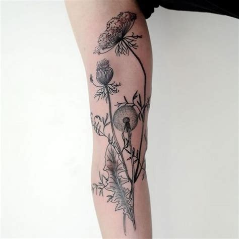 very realistic looking black ink flowers tattoo on arm tattooimages