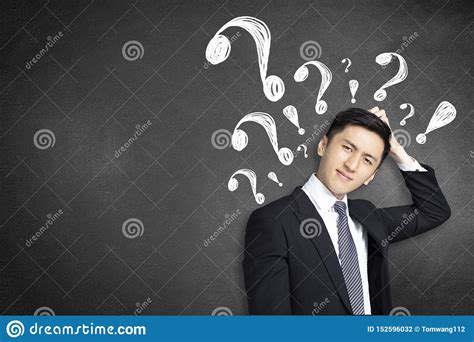 Confused Young Businessman Scratching His Head With Question Mark Stock