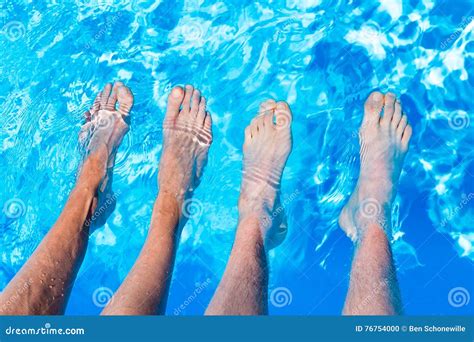 Four Bare Legs Feet In Water Of Swimming Pool Stock Photo Image Of