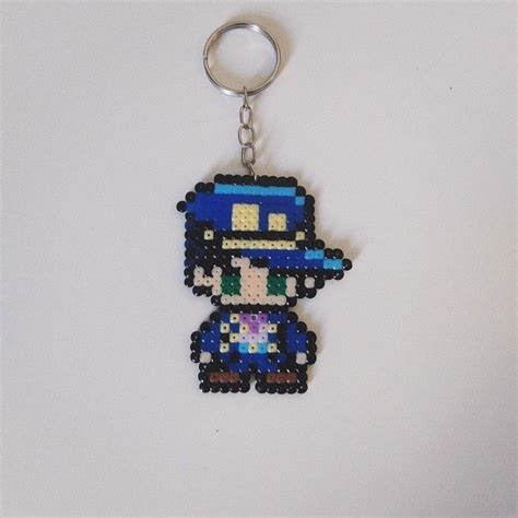 A Keychain Made Out Of Legos And Beads With A Pixel Figure On It