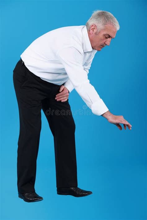 Businessman Picking Up Droppings With A Shovel Stock Photo Image Of