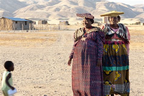 Two Herero Woman In Traditional Dress And Horned Hats Purros Village