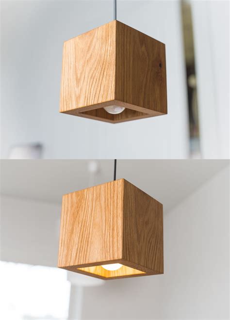 Two Square Wooden Lights Hanging From The Ceiling