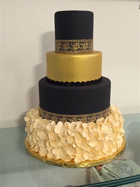 Black Gold And Ivory Wedding Cake With Ruffled Base And Gold Lace