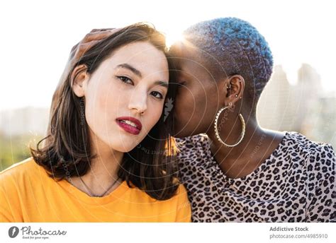 Multi Ethnic Lesbian Couple Hugging Outdoors A Royalty Free Stock