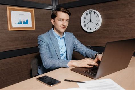 Photo Of Handsome Young Manager Working With Laptop And Business