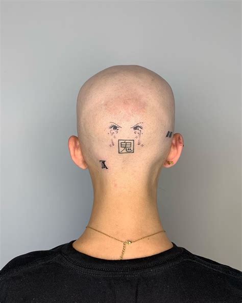 A Bald Man With Tattoos On His Head