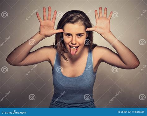 Woman With Funny Face Mocking Someone Sticking Her Tongue Out Stock