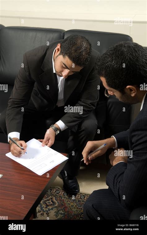 Two Middle Eastern Men Signing Contracts Inside Office Beirut Lebanon