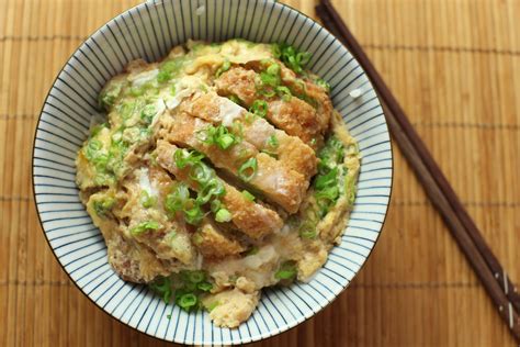 A Fried Chicken Or Pork Cutlet On A Bed Of Steaming Rice The Whole Thing Topped With Beaten