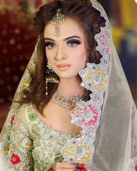 A Woman Wearing A Bridal Outfit And Jewelry
