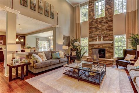 Windows Flank A Soaring Stone Fireplace In This Two Story Great Room