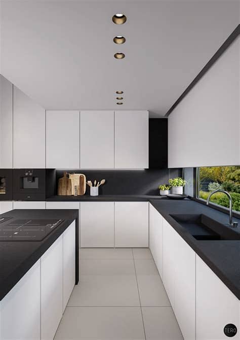 The combination of white and orange make it feel warm. 40 Beautiful Black & White Kitchen Designs