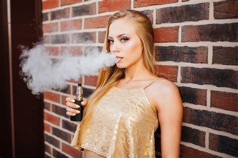 Vaping Young Beautiful Girl Smoking Vaping E Cigarette With Smoke Outdoors Vapor Concept