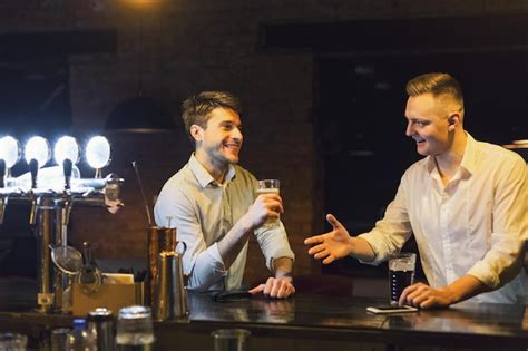 Premium Photo Friendly Talk In Bar Two Happy Young Men Talking To Each Other And Drinking