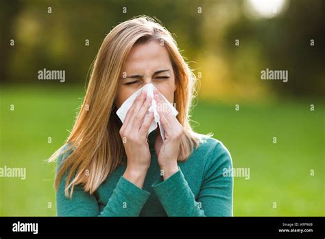 Woman With Allergy Symptom Blowing Nose Stock Photo Alamy