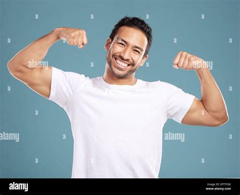 Handsome Young Mixed Race Man Flexing His Biceps While Standing In