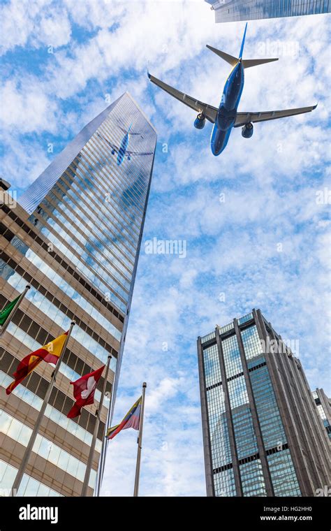 Plane Flying Over The City Stock Photo Alamy