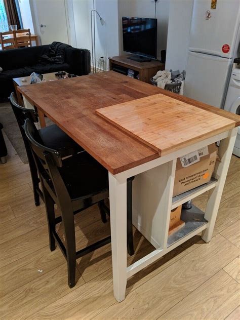 Breakfast Bar Kitchen Island With Two Stools And Chopping Board