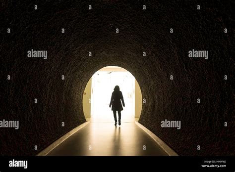 Woman Walks Through Tunnel Stock Photo Alamy
