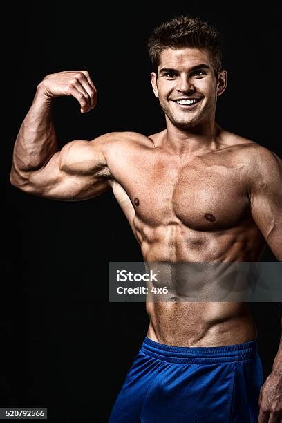 Cheerful Muscular Man Flexing Muscle Stock Photo Download Image Now