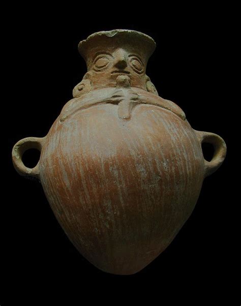 An Old Vase With A Face On It