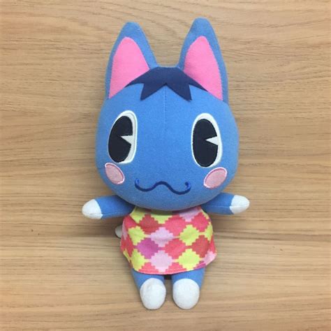 A rosie plush holding a watering can and flower. For sale is an Animal Crossing Rosie Cat Plush Soft Toy ...