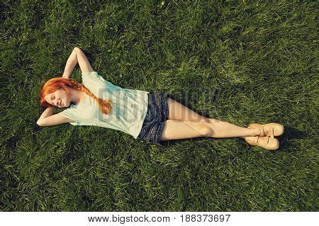 Relaxing Redhead Girl Lying On The Grass Woman Relaxation Outdoor