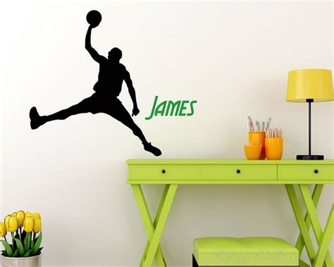 A Wall Decal With A Basketball Player Jumping Up To Dunk It In The Air