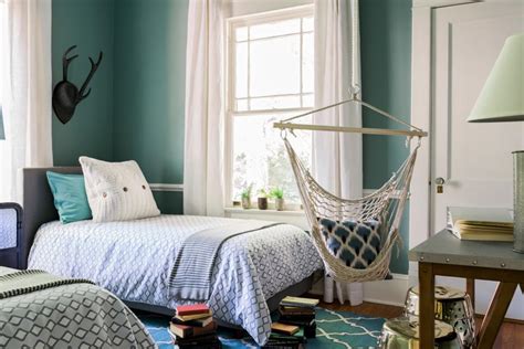 Fabulous shared boys' bedroom features twin beds on one shared headboard flanking a shared nightstand a peacock blue lamp under a light brown juju hat illuminated by swing arm wall sconces. Ideas for Shared Boys' Bedroom | HGTV