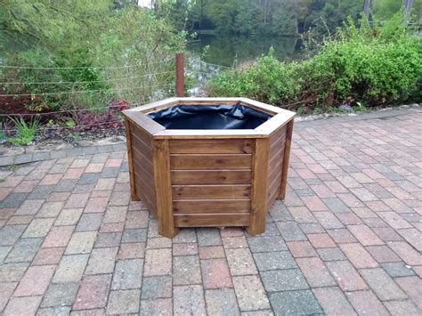 Aston Hexagonal Wooden Planters Stained With Warm Oak Woodstain