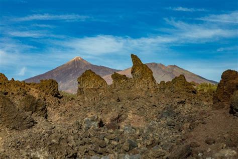 Mountains And Lava Fields Around Volcano Teide Partly Covered By The