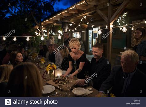 Waitress Serving Food To Friends At Outdoor Dinner Harvest Party Stock