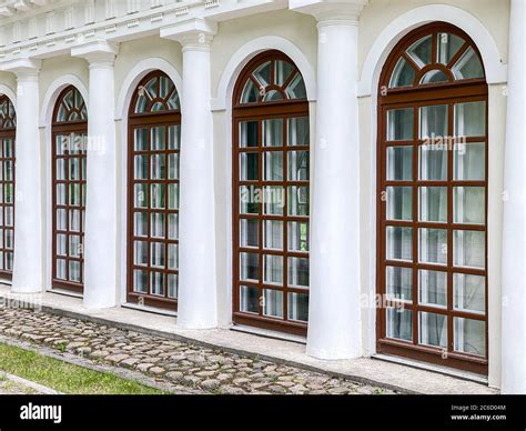 Vintage Building Facade With Arched French Windows And Columns Classic