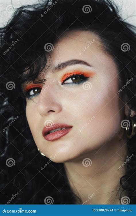 Beautiful Young Brunette Model With Bright Make Up And Curly Hairstyle