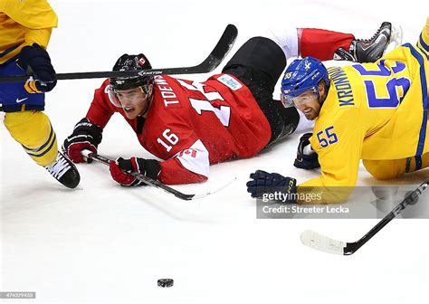 Jonathan Toews Of Canada And Niklas Kronwall Of Sweden Fall To The