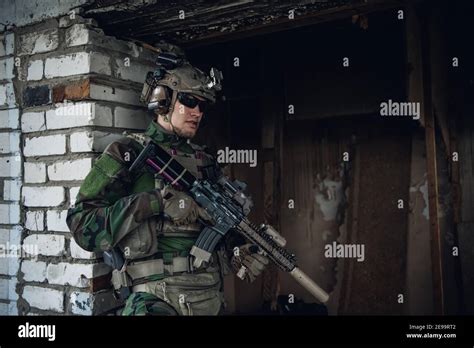 Military Man With Assault Rifle Standing Inside Building He Is Ready