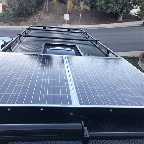 Aluminess Roof Rack With Solar Panels And A Place To Hang Out On Top Of
