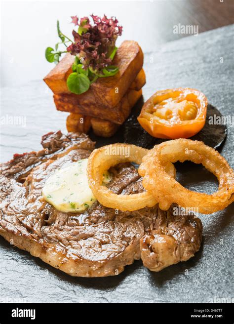 Steak And Onion Rings Served With Chunky Chips Stock Photo Alamy