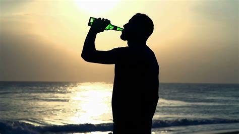 Man Drinking Beer On The Beach During Sunset Steadycam Shot Slow