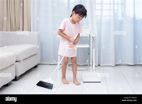 Asian Chinese Little Girl Helping Doing Cleaning With Broom And Dustpan