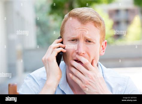 Closeup Portrait Worried Young Man In Blue Shirt Talking On Phone To