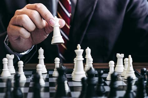 Close Up Of Businessman Playing Chess Game 1241502 Stock Photo At Vecteezy